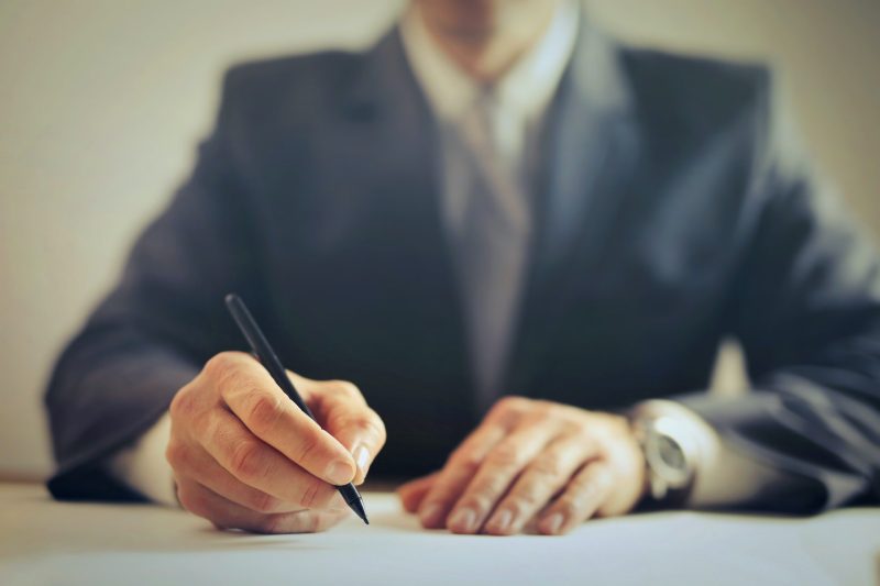 A businessman signing a contract settlement